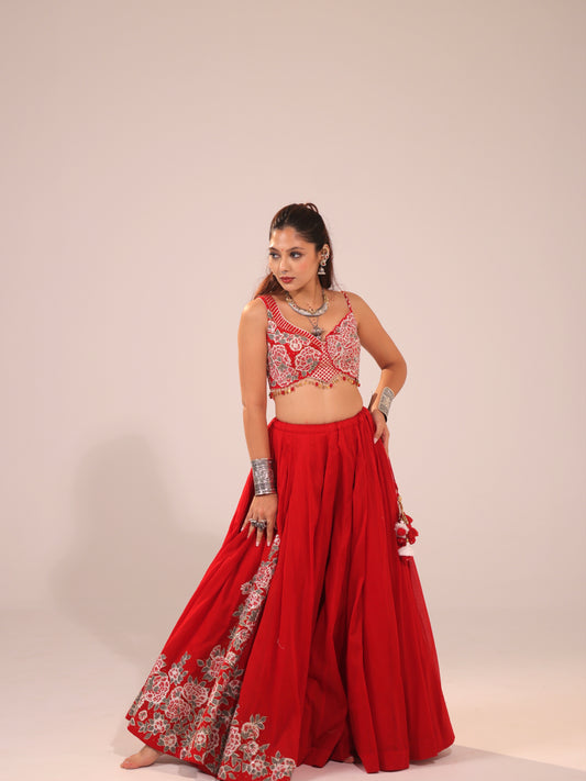 Front full-length view of a model wearing a crimson red cotton chaniya choli set featuring silver floral threadwork along the skirt hem and an embroidered V-neck choli for Navratri garba.